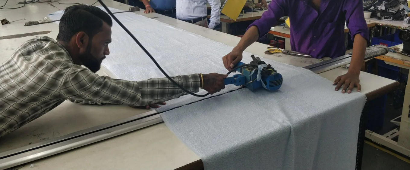 Cutting fabric to size on the cutting table