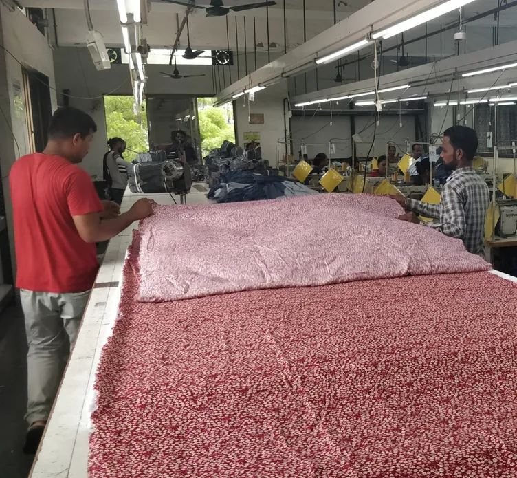 Spreading printed fabric across the cutting table